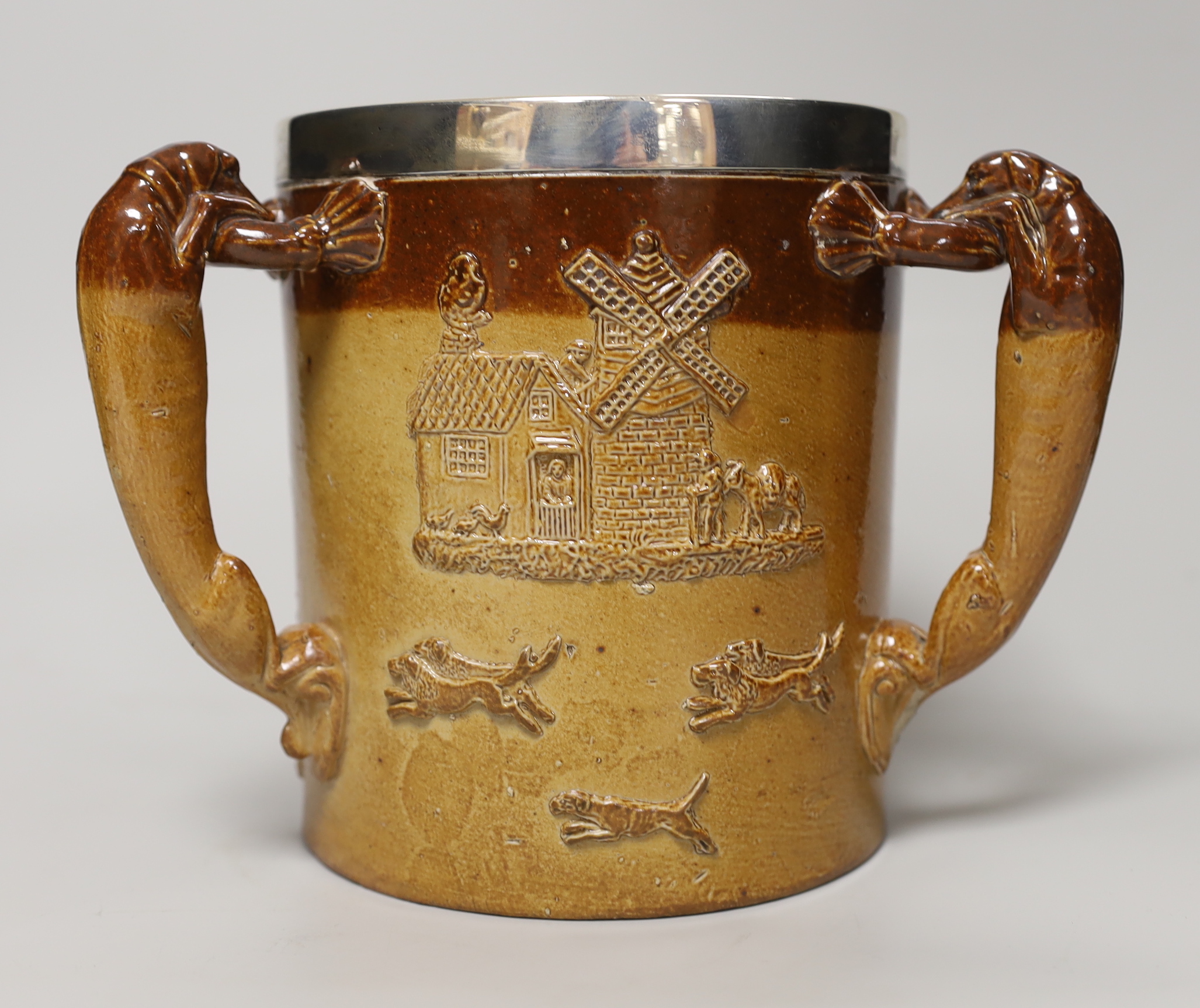 A Doulton Lambeth stoneware three handled tyg with silver collar, hallmarked London 1885, 18cm high